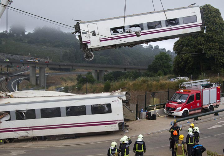 A crane removes a derailed  car at the site of a train accident near the city of Santiago de Compostela on July 25, 2013. 
