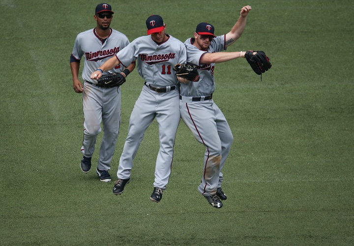 TORONTO, CANADA - JULY 6: Aaron Hicks #32 of the Minnesota Twins celebrates with Clete Thomas #32 and Chris Parmelee #27 after their victory during MLB game action against the Toronto Blue Jays on July 6, 2013 at Rogers Centre in Toronto, Ontario, Canada.