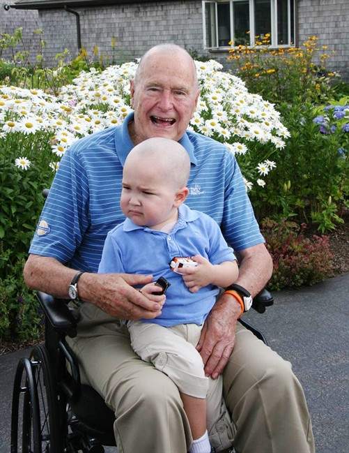 This Wednesday July 24, 2013 photo provided by the Office of George Bush shows President George H. W. Bush with Patrick (last name withheld at family's request), 2, in Kennebunkport, Maine.