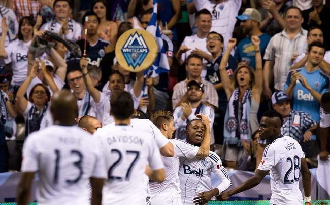 Vancouver Whitecaps' Darren Mattocks, centre right, of Jamaica, celebrates his goal against the Seattle Sounders during the second half of an MLS soccer game in Vancouver, B.C., on Saturday July 6, 2013. THE CANADIAN PRESS/Darryl Dyck.