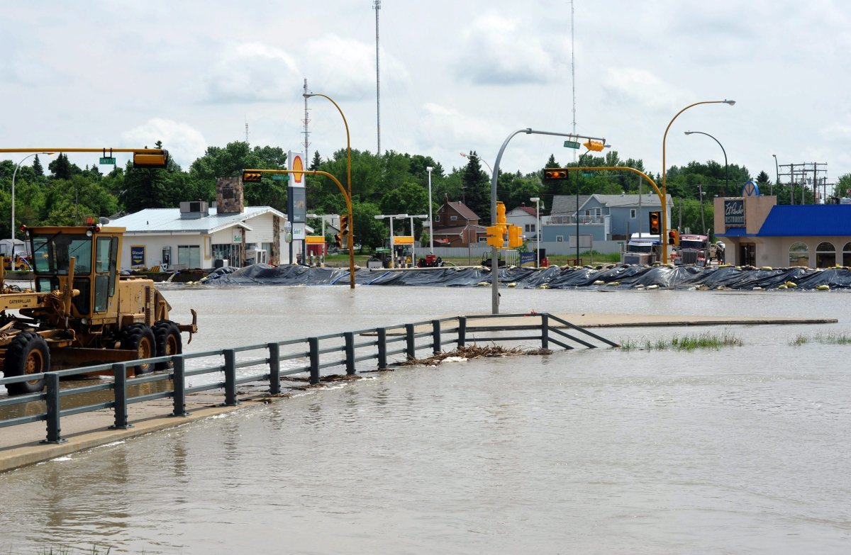 An intersection of highways 39 and 35 in Weyburn sits completely submerged in southeast Saskatchewan on Monday, June 20, 2011. Communities across soggy southeastern Saskatchewan are dealing with displaced residents, sewage-flooded basements and suspect drinking water. 