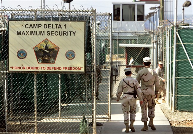  In this June 27, 2006 file photo, reviewed by a U.S. Department of Defense official, U.S. military guards walk within Camp Delta military-run prison, at the Guantanamo Bay U.S. Naval Base, Cuba. 