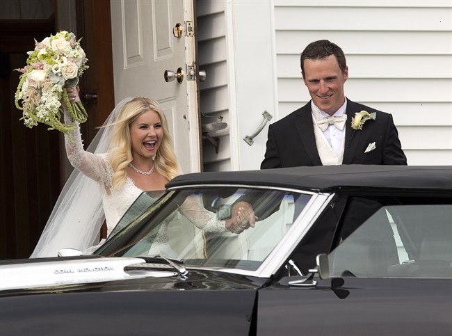 Elisha Cuthbert and Dion Phaneuf exit a church in PEI following their wedding.