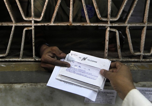 An Indian staff member, foreground, of central telegraph office dispatches telegrams, in Mumbai, India. The state-run telecom firm Bharat Sanchar Nigam Limited (BSNL) decided to discontinue the 160-year-old telegram service from July 15, 2013 in India once a source of quick and urgent communication. The decision is attributed to advent of technology and newer and faster means of communication, which are commercially more viable. 