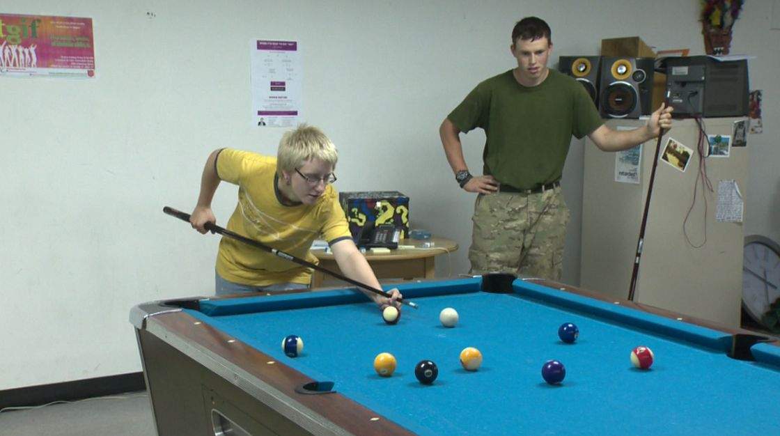 Kaitlyn Tamsley (L) plays pool at the St. Albert Youth Centre. 
