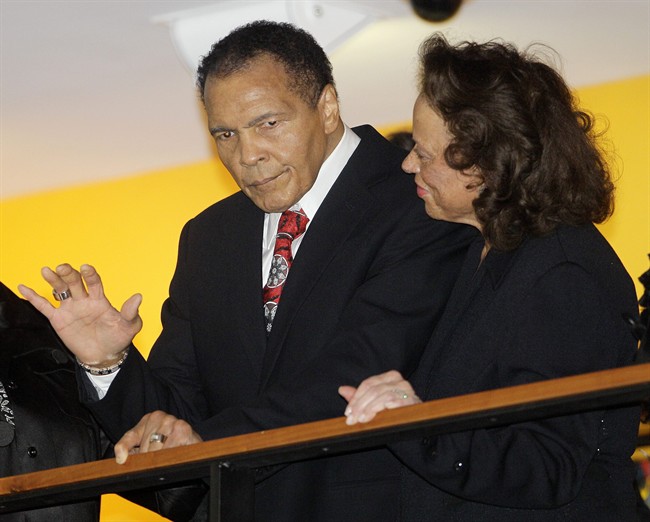 In this Jan. 14, 2012 file photo, boxing great Muhammad Ali, with his wife, Lonnie, right, waves to friends attending a celebration for his 70th birthday at the Muhammad Ali Center in Louisville, Ky.