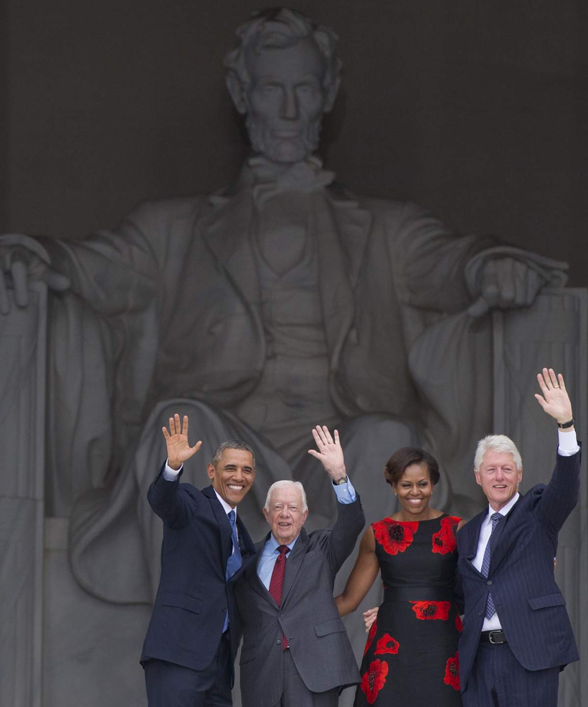 President Barack Obama waves with his wife Michelle Obama and former Presidents Jimmy Carter and Bill Clinton during the ceremony to commemorate the 50th anniversary of the March on Washington for Jobs and Freedom August 28, 2013 in Washington, DC.