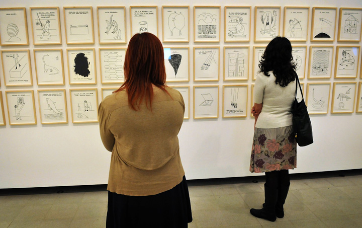 Women browse artworks on display at a press preview of the new exhibition 'Brain Activity' by British Artist David Shrigley at The Hayward Gallery on January 31, 2012 in London, England. 