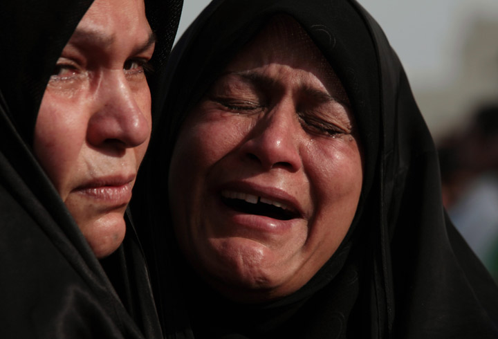 Bahraini women mourn for two young men killed in a car crash during their politically-charged funeral Friday, Aug. 2, 2013, in Sitra, Bahrain. 