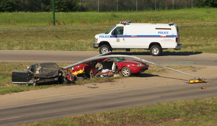 Traffic light pole ends up on top of car after two vehicle collision on College Drive.