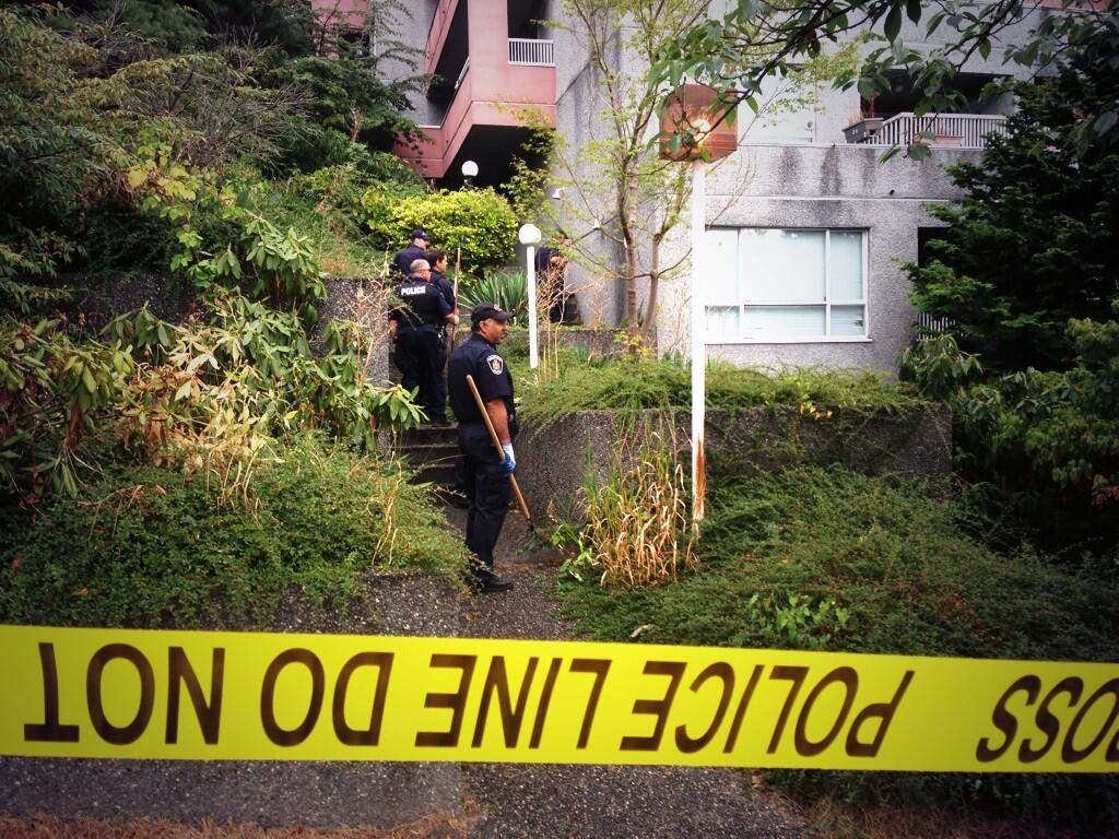 Police comb the property at 211 11th Street in New Westminster where two women have been found dead in the past two weeks.