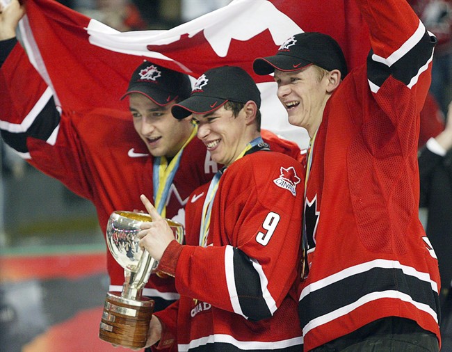 From left, Canada’s Patrice Bergeron, Sidney Crosby and Corey Perry celebrate the gold medal at the World Junior Hockey Championships in Grand Forks, N.D., Jan. 4, 2005.