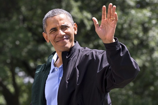 President Barack Obama waves to the media as he walks on the South Lawn of the White House in Washington after returning on Marine One from Camp David, Md., where he spent his birthday Sunday, Aug. 4, 2013.