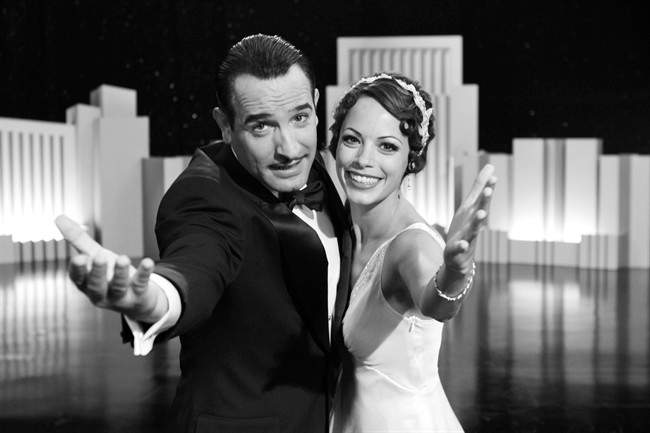 In this film publicity image released by The Weinstein Company, Jean Dujardin portrays George Valentin, left, and Berenice Bejo portrays Peppy Miller in a scene from "The Artist.".