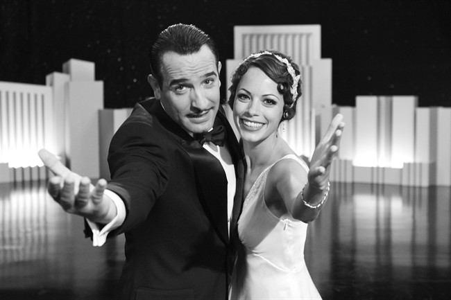 In this film publicity image released by The Weinstein Company, Jean Dujardin portrays George Valentin, left, and Berenice Bejo portrays Peppy Miller in a scene from "The Artist.".