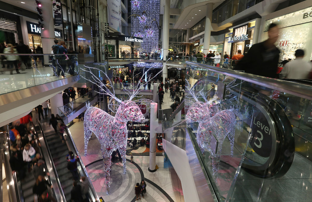 Shoppers rush about a busy Eaton Centre in Toronto on December 22, 2012.