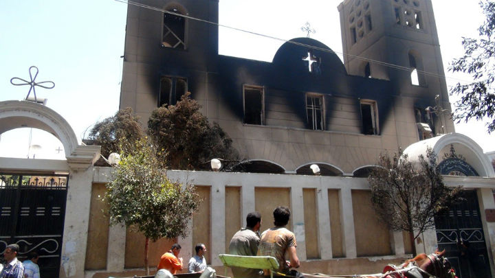 A picture taken on August 14, 2013, shows the facade of the Prince Tadros Coptic church after being torched by unknown assailants in the central Egyptian city of Minya. Egypt's Christians are living in fear after a string of attacks against churches, businesses and homes they say were carried out by angry supporters of ousted Islamist president Mohamed Morsi. 