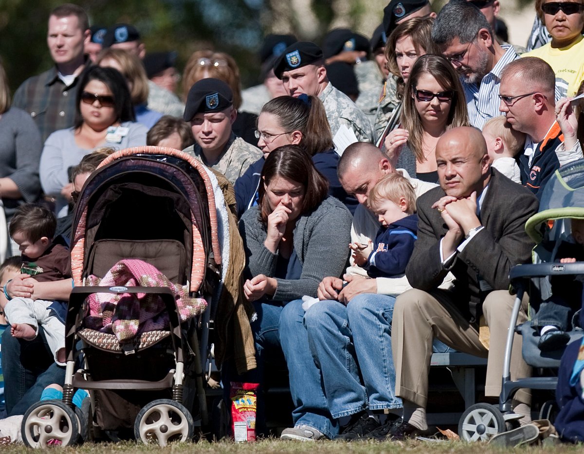 FORT HOOD, TX - NOVEMBER 5: A family observes a moment of silence at a remembrance service honoring the 13 victims killed in the Ft. Hood attacks on the one year anniversary in Killeen, Texas on November 5, 2010.