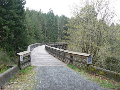 Police arrested a man for blocking a trail and waving a knife at a cyclist in Victoria.