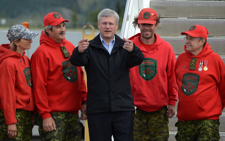 rime Minister Stephen Harper is greeted by a group of Canadian Rangers as he arrives in Whitehorse, Yukon on Sunday, August 18, 2013.Whitehorse is Harper's first stop on his annual northern Canada tour. THE CANADIAN PRESS/Sean Kilpatrick.