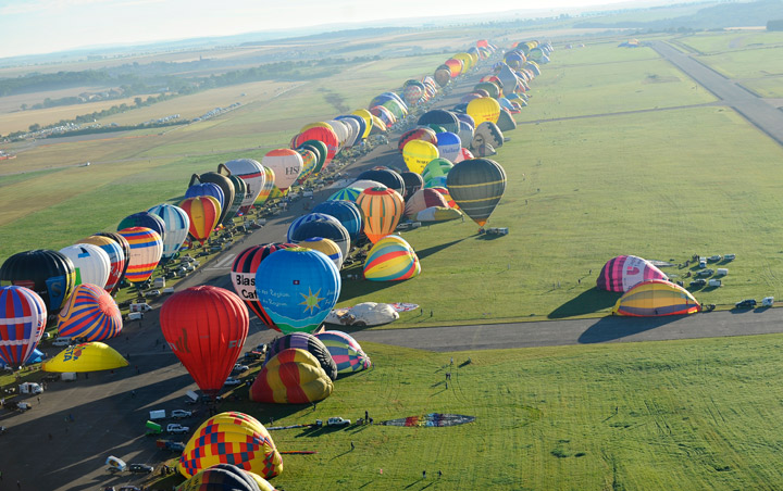 Hot air-balloons are about to fly over Chambley-Bussieres, eastern France, before the world record attempt of the biggest line with 391 balloons on August 1, 2013.  (Getty Images)