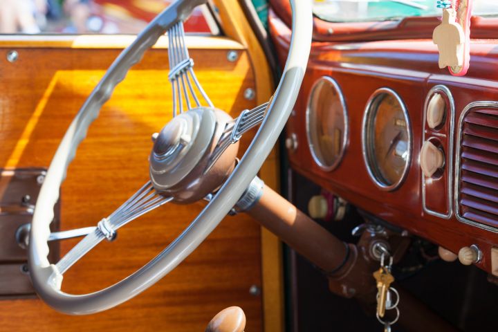 Steering wheel and dashboard of a vintage car.