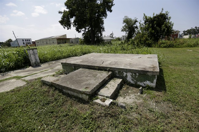 A foundation of a former structure is seen with new construction from the Make It Right Foundation in the background, in the Lower 9th Ward in New Orleans, Wednesday, Aug. 28, 2013. Thursday marks the eighth anniversary of Hurricane Katrina, which devastated the area. 