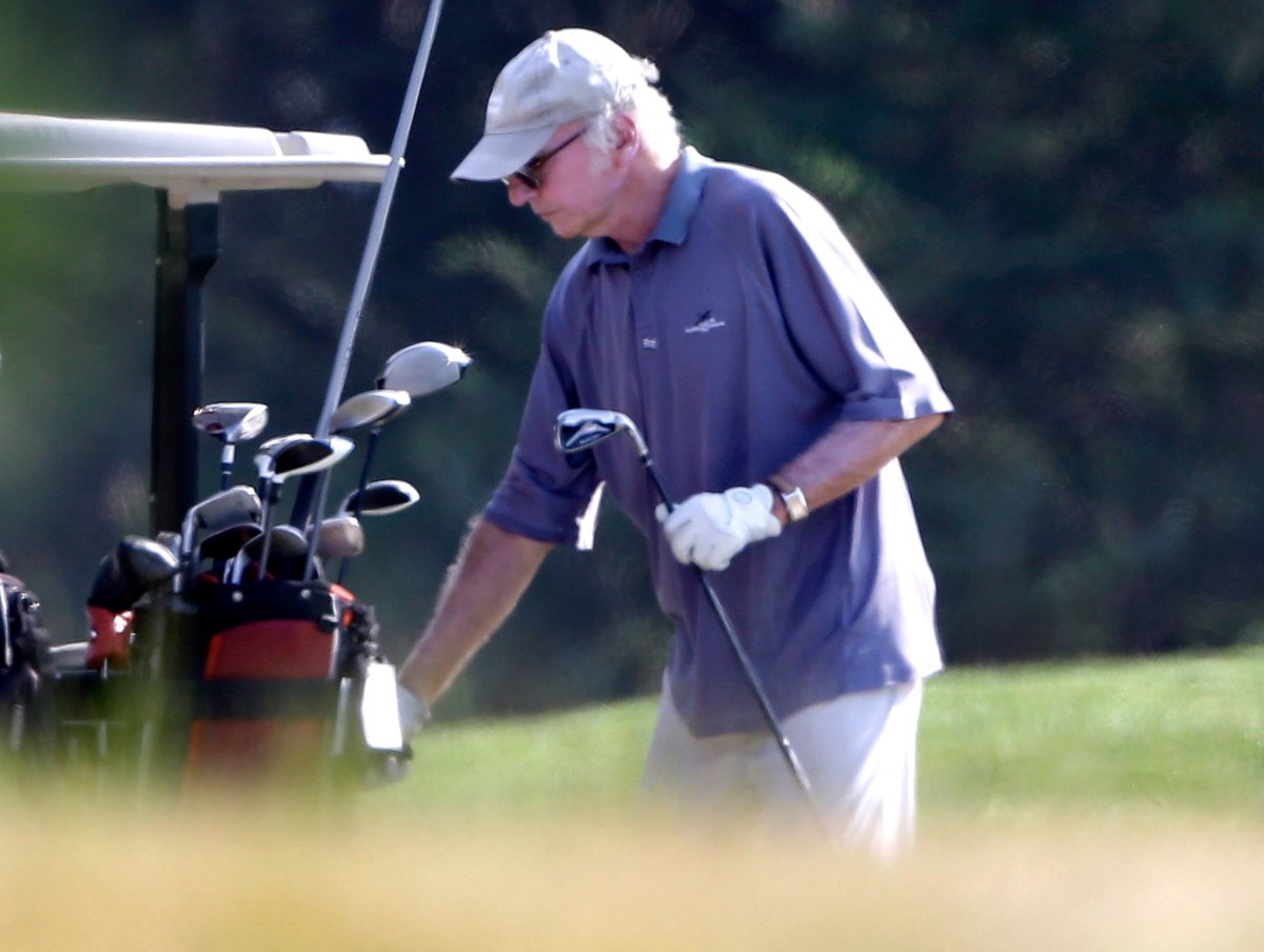 Actor Larry David returns a club to the cart while playing golf with President Barack Obama, not shown, at Farm Neck Golf Club in Oak Bluffs, Mass., on the island of Martha's Vineyard, Saturday, Aug. 17, 2013. 