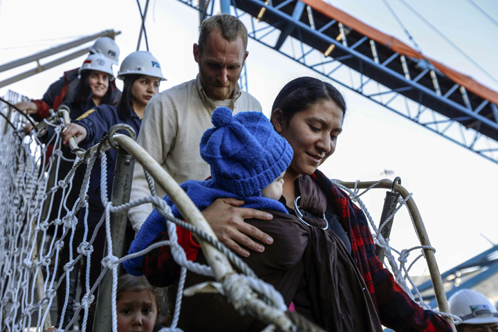 Hannah Gastonguay, holding her baby Rahab, is followed by her husband Sean and the couple's 3-year-old daughter Ardith, as they disembark in the port city of San Antonio, Chile, Friday, Aug. 9, 2013. 