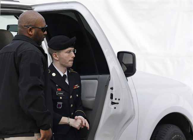 Army Pfc. Bradley Manning steps out of a security vehicle as he is escorted into a courthouse in Fort Meade, Md., Wednesday, Aug. 21, 2013, before a sentencing hearing in his court martial. The military judge overseeing Manning's trial said she will announce on Wednesday his sentence for giving reams of classified information to WikiLeaks. (AP Photo/Patrick Semansky)
.