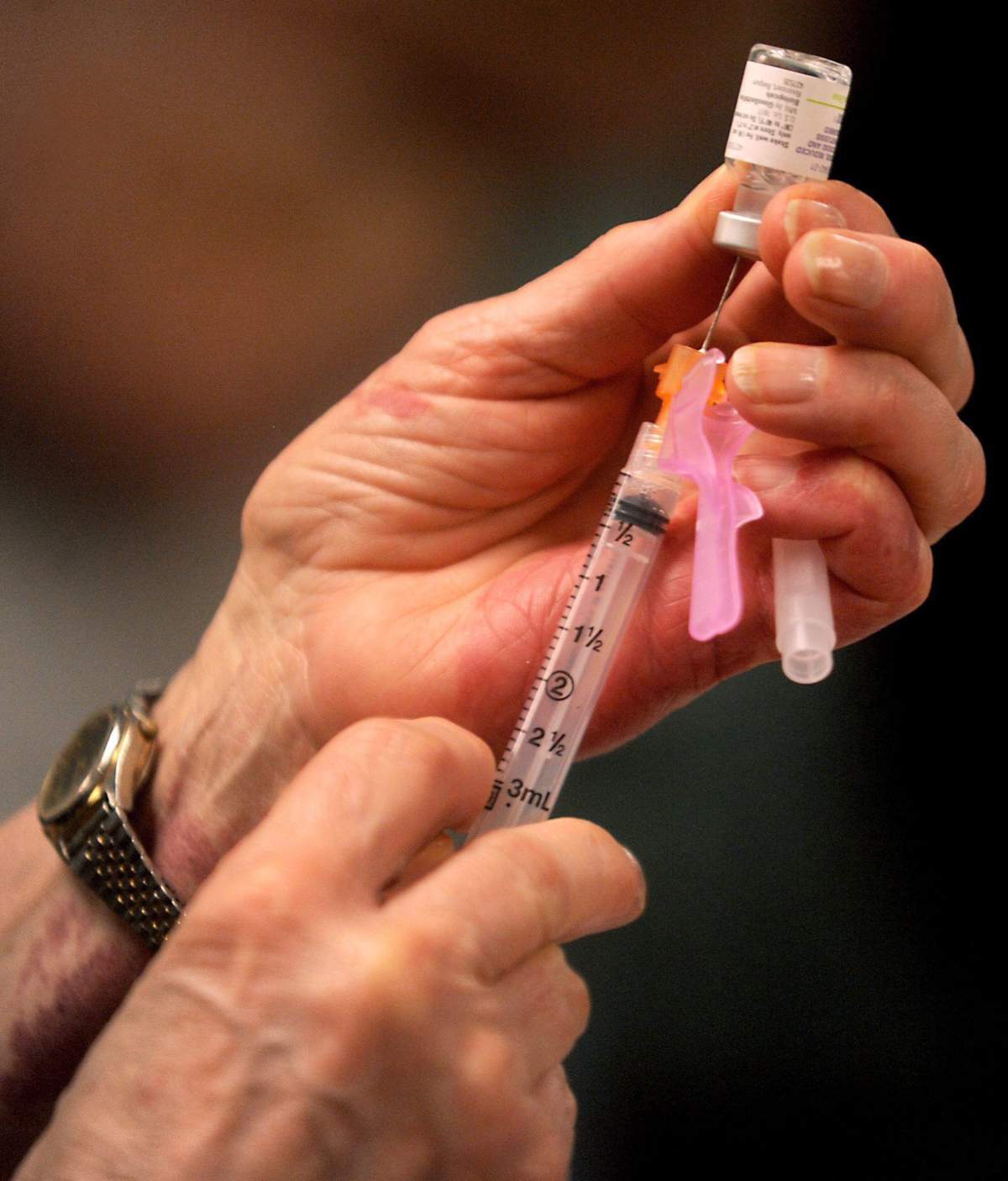 A file photo of a woman preparing to administer a vaccination. 
