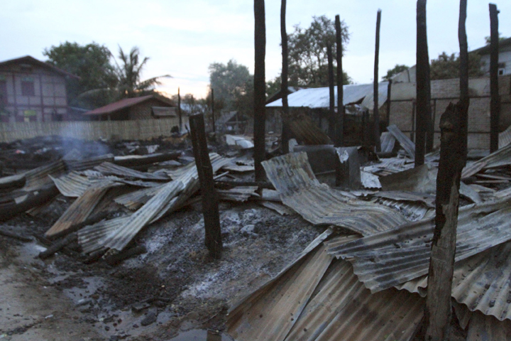 Debris of burning buildings in Htan Gone village of Kantbalu township, Sagaing division Myanmar, Sunday, Aug 25, 2013.