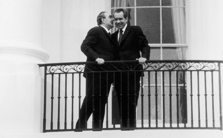 Russian leader Leonid Brezhnev (1906 - 1982) whispers an aside to smiling American President Richard Nixon (1913 - 1994) on the White House portico during a state visit, Washington DC, June 21, 1973.