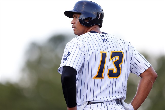 New York Yankees' Alex Rodriguez stands on first base after drawing a walk during the first inning of a Class AA baseball game with the Trenton Thunder against the Reading Phillies Saturday, Aug. 3, 2013, in Trenton, N.J. 