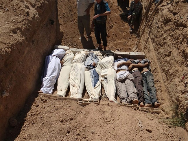 A photo from Aug. 21, shows the burial of several bodies following an attack in the suburb of Damascus, Syria. There is mounting proof that the government used chemical weapons.