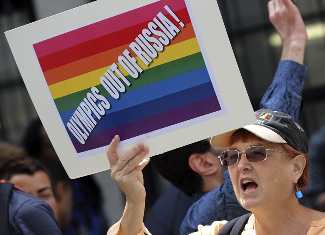 A gay rights activist chant slogans during a demonstration in front of the Russian consulate in New York, Wednesday, July 31, 2013.
