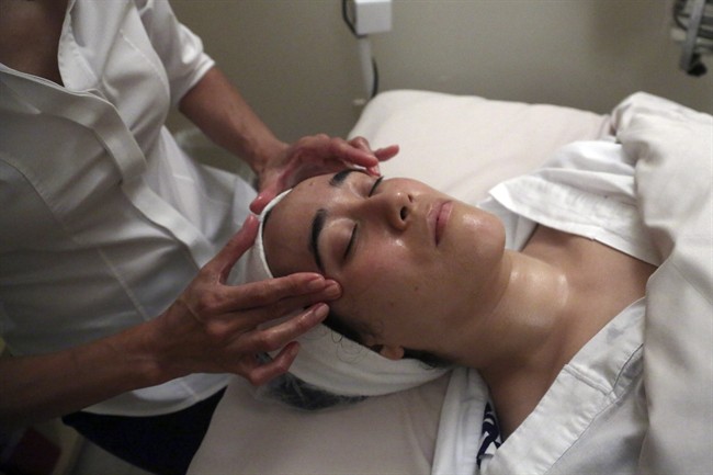 In this Wednesday, July 17, 2013 photo, salon owner Shizuka Bernstein gives what she calls a Geisha Facial to Mari Miyoshi at Shizuka New York skin care in New York. The facial, which Bernstein has been offering for five years, is a traditional Japanese treatment using imported Asian nightingale excrement mixed with rice bran, and goes for $180 a pop. (AP Photo/Mary Altaffer).