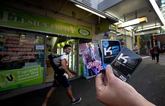 This April 25, 2013 photo shows packets of K2, synthetic cannabis product, held up outside a store in Auckland. New Zealand.