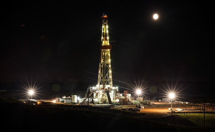 File -- An oil derrick operated by Raven Drilling drills for oil in the Bakken shale formation on July 23, 2013 outside Watford City, North Dakota.