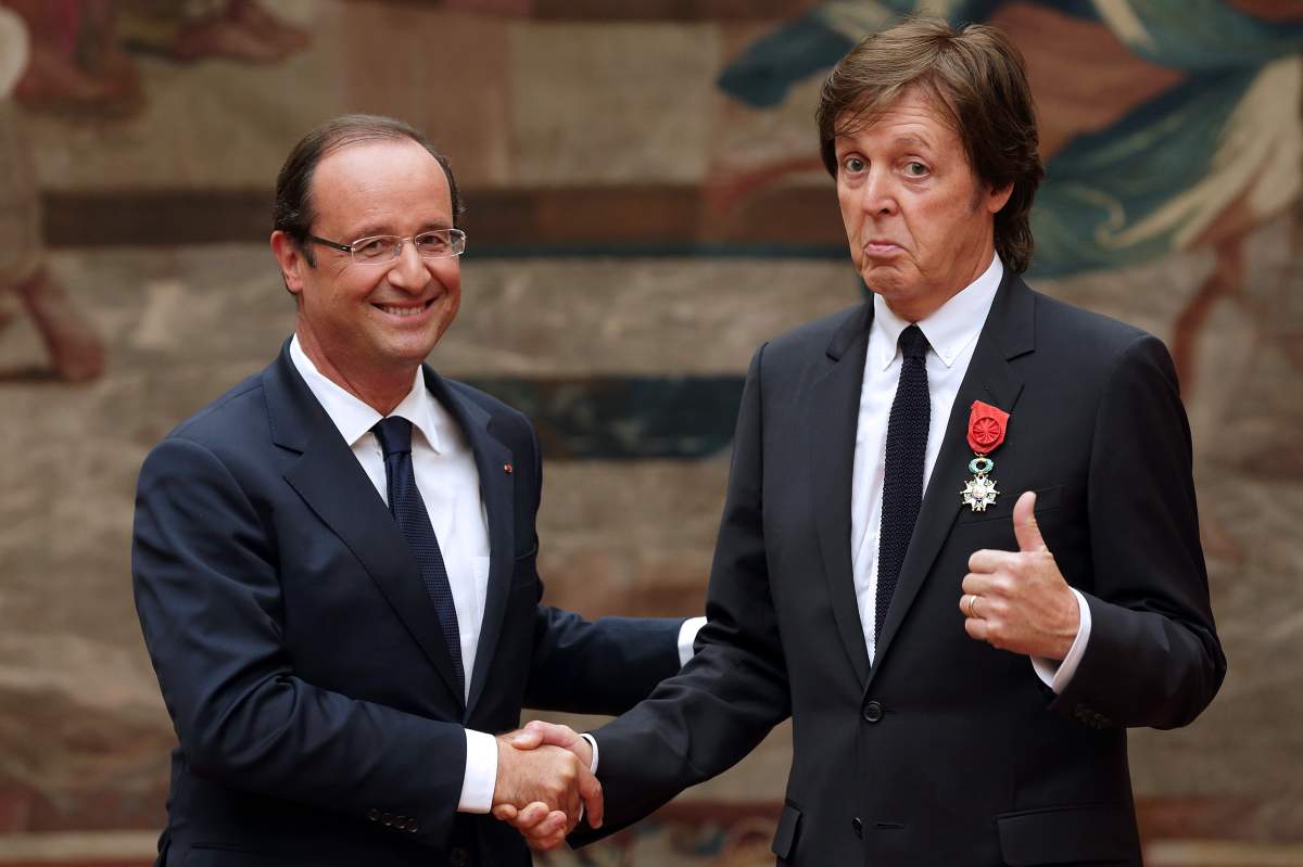 France's president Francois Hollande (L) shakes hands with former Beatles' singer Sir Paul McCartney after awarding him as officer of the 'Legion d'Honneur' (Legion of honour), the French hightest award on September 8, 2012 at the Elysee Presidential Palace in Paris.