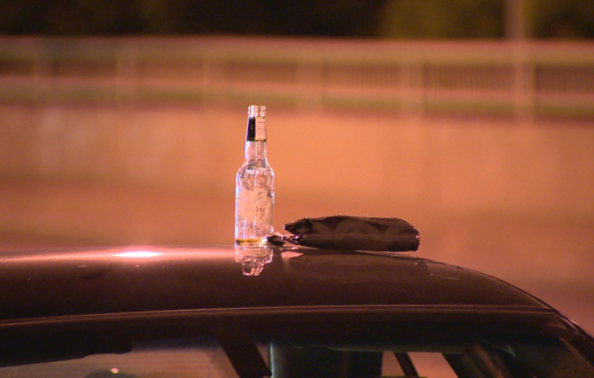 A bottle is recovered from a vehicle at a RIDE check point on August 14, 2013.