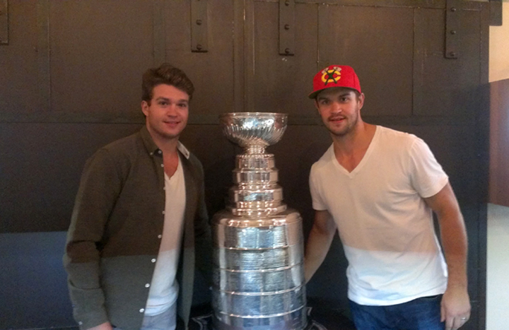 Keith Seabrook (left) and Brent Seabrook (right) pose with the Stanley Cup at Cavalier in Gastown on Aug. 30. 