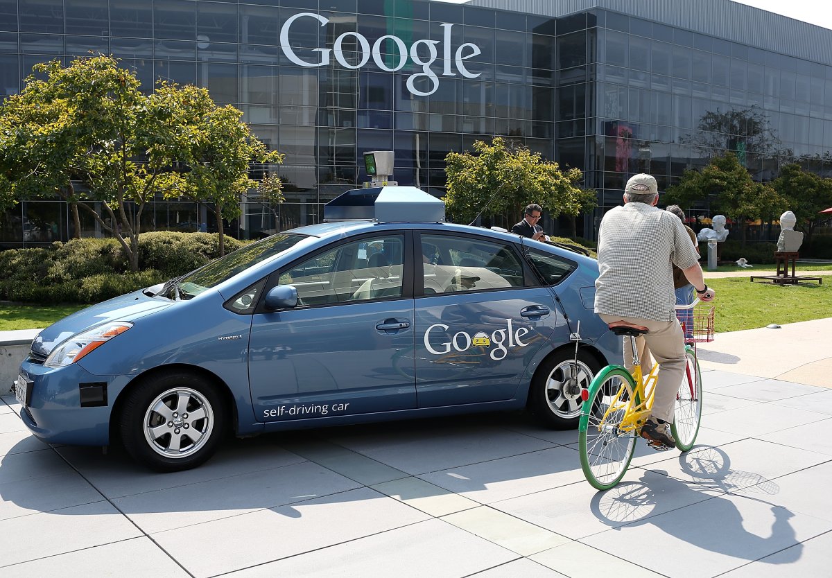 MOUNTAIN VIEW, CA - SEPTEMBER 25: A bicyclist rides by a Google self-driving car at the Google headquarters on September 25, 2012 in Mountain View, California. California Gov. Jerry Brown signed State Senate Bill 1298 that allows driverless cars to operate on public roads for testing purposes. The bill also calls for the Department of Motor Vehicles to adopt regulations that govern licensing, bonding, testing and operation of the driverless vehicles before January 2015.
