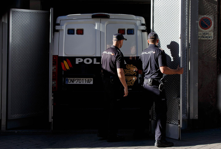 Police officers open security gates where the prison van transporting convicted paedophile Daniel Galvan Vina is parked at Audiencia Nacional court on August 6, 2013 in Madrid, Spain.