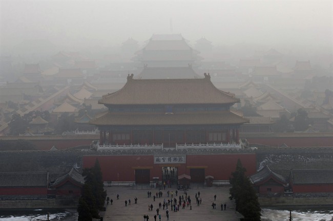 Visitors gather near an entrance to the Forbidden city during a very hazy day in Beijing. China, one of the most visited countries in the world, has seen sharply fewer tourists this year, with worsening air pollution partly to blame. (AP Photo/Ng Han Guan, File).