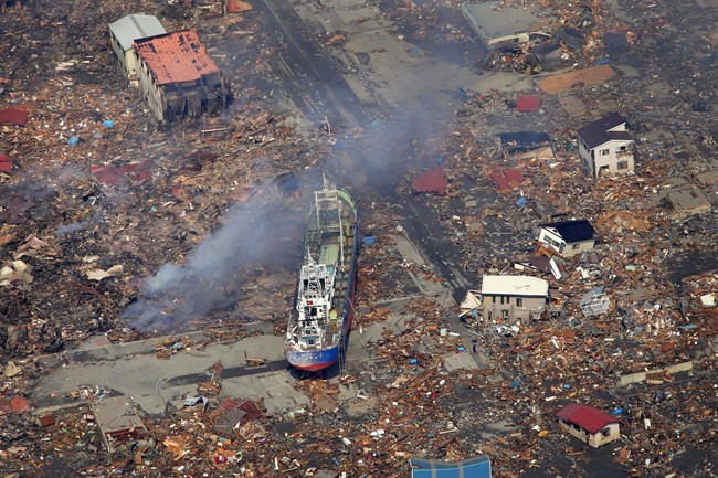 In this March 13, 2011 file photo, a ship washed away by a tsunami sits amid debris in Kesennuma, Miyagi Prefecture after Japan's biggest recorded earthquake hit its eastern coast. A new report suggests a similar scale quake on the B.C. coast could send Canadian economy into distress for years.