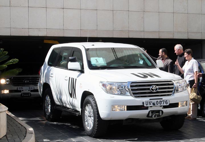 United Nations High Representative for Disarmament Affairs, Angela Kane (R), and Ake Sellstrom (C), the head of the UN chemical weapons investigation, wait for their vehicles with other members of their team before leaving a hotel in Damascus on August 28, 2013 to a site in the Syrian capital of alleged chemical weapons attacks, a day after suspending their mission over safety concerns. 