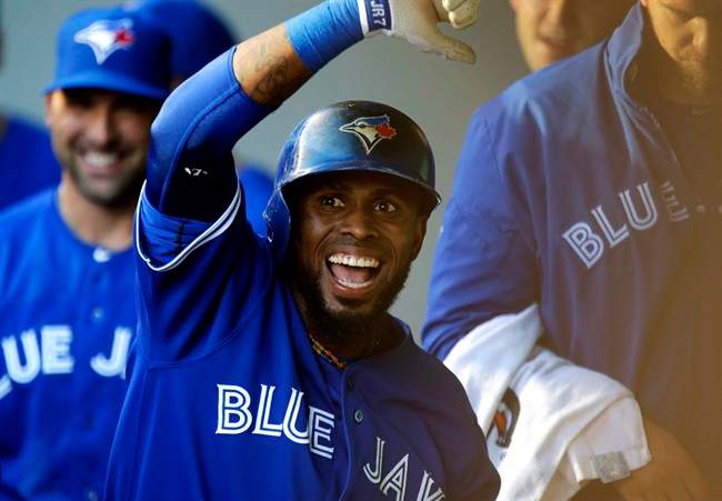 Toronto Blue Jays' Jose Reyes celebrates in the dugout after he hit a solo home run off of Seattle Mariners starting pitcher Felix Hernandez in the first inning of a baseball game, Tuesday, Aug. 6, 2013, in Seattle. 