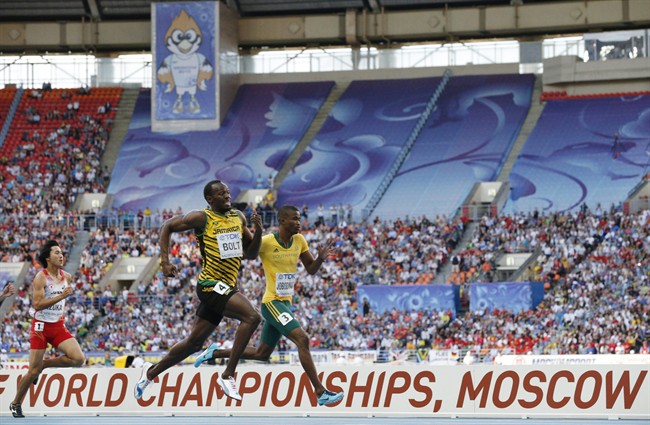 Jamaica's Usain Bolt, center, South Africa's Anaso Jobodwana, right, and Japan's Shota Iizuka compete in a men's 200-meter semifinal at the World Athletics Championships in the Luzhniki stadium in Moscow, Russia, Friday, Aug. 16, 2013. (AP Photo/Alexander .