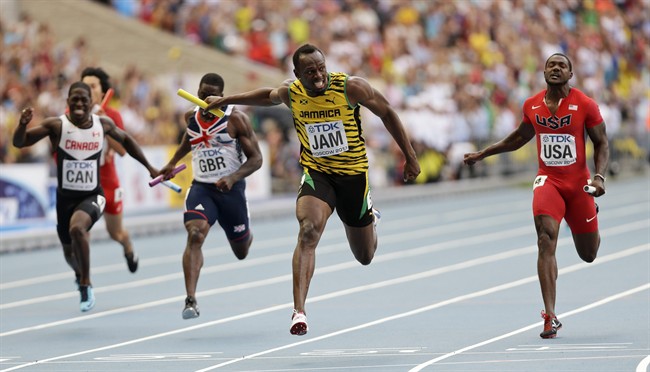 Jamaica's Usain Bolt, second from right, crosses the finish line to win ahead of United States' Justin Gatlin, right, and Britain's Dwayne Chambers, second from left, in the men's 4x100-meter relay final at the World Athletics Championships in the Luzhniki stadium in Moscow, Russia, Sunday, Aug. 18, 2013. (AP Photo/Anja Niedringhaus).